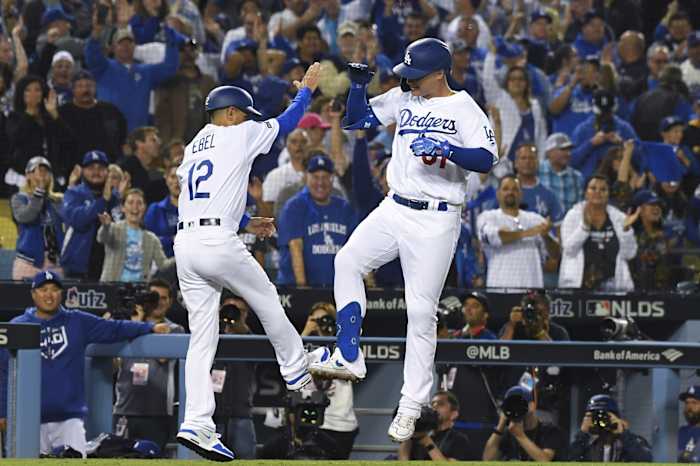 Oct 3, 2019; Los Angeles, CA, USA; Los Angeles Dodgers left fielder Joc Pederson (31) celebrates with third base coach Dino Ebel (12) after a solo home run during the eighth inning in game one of the 2019 NLDS playoff baseball series against the Washington Nationals at Dodger Stadium.